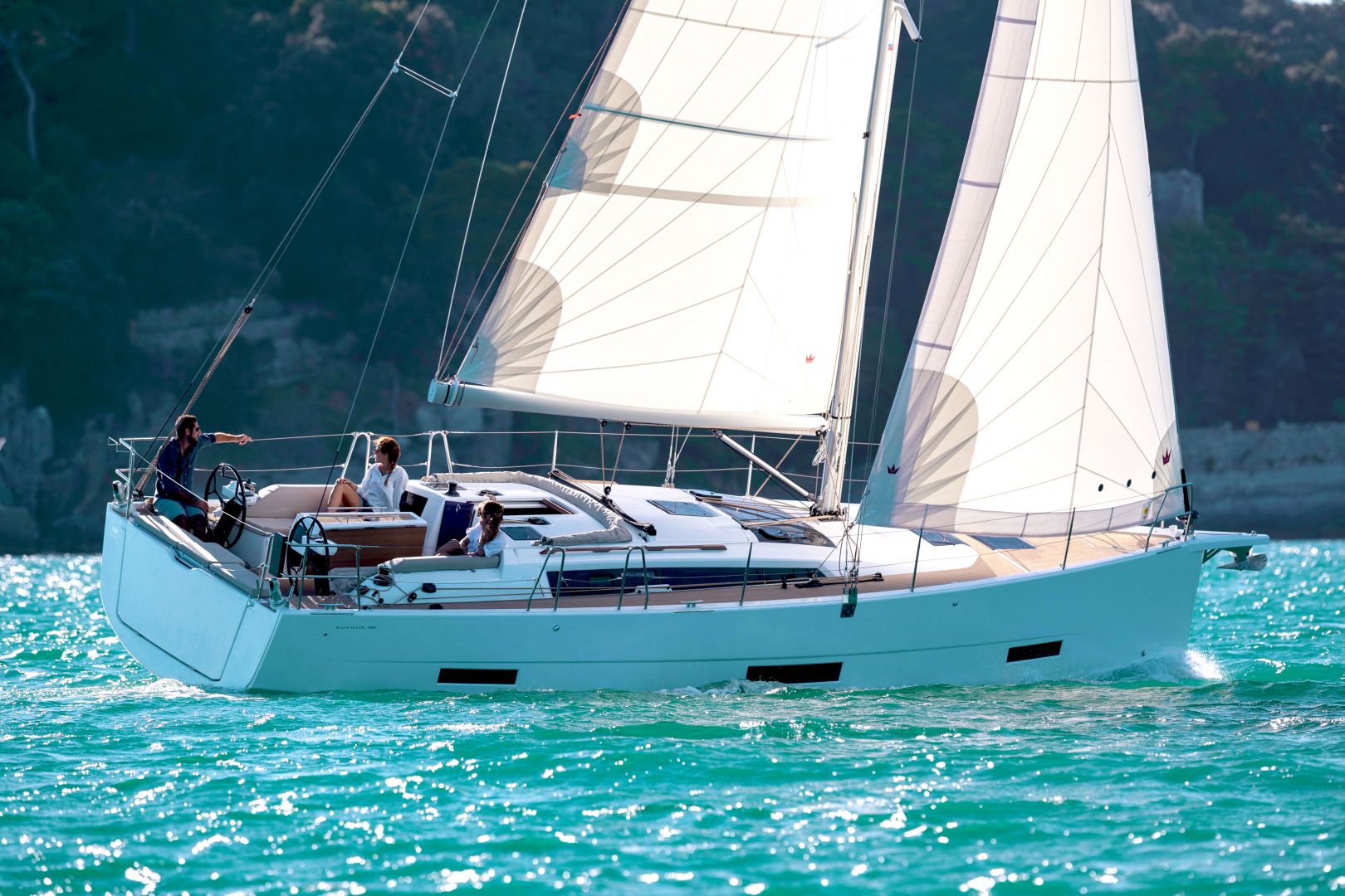 Dufour sailboat cruiser sailing on blue green water